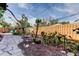 This backyard offers a stone walking path, a garden area, and a wooden fence ensuring privacy at 919 Sandpiper S Way, St Petersburg, FL 33707