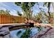 Relaxing backyard with a stone-lined pool surrounded by lush tropical landscaping at 919 Sandpiper S Way, St Petersburg, FL 33707