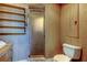 This bathroom features wood paneling, an enclosed shower, and white toilet at 919 Sandpiper S Way, St Petersburg, FL 33707