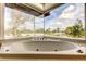 Close-up of a bright, modern bathtub with jets and a beautiful neighborhood view at 919 Sandpiper S Way, St Petersburg, FL 33707
