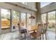 Bright dining room features a decorative pendant light and views to the landscaped backyard through the large windows at 919 Sandpiper S Way, St Petersburg, FL 33707