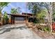 Charming home exterior with mature landscaping and a two-car garage at 919 Sandpiper S Way, St Petersburg, FL 33707