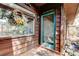 Inviting front entry featuring a wreath, stained glass door, and rustic wood siding at 919 Sandpiper S Way, St Petersburg, FL 33707