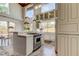 Open kitchen with a cooktop island, white cabinets, and pendant lighting, creating a bright and functional space at 919 Sandpiper S Way, St Petersburg, FL 33707