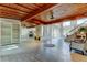Open living space with wood ceiling, tile flooring, fireplace, and staircase at 919 Sandpiper S Way, St Petersburg, FL 33707