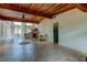 Expansive living area featuring wood beamed ceilings, tile flooring, and a staircase at 919 Sandpiper S Way, St Petersburg, FL 33707
