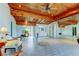 Spacious living area with wood beamed ceilings, tile floors, and large windows for natural light at 919 Sandpiper S Way, St Petersburg, FL 33707