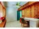 Office space with wood-paneled walls, ceiling fan and built-in shelving at 919 Sandpiper S Way, St Petersburg, FL 33707