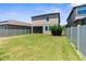 Spacious backyard features a well-maintained lawn and a white vinyl fence for privacy at 9929 Ivory Dr, Sun City Center, FL 33573