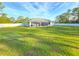 Large backyard with manicured lawn, fenced perimeter, and screened in patio at 11240 Marvelwood, Brooksville, FL 34614