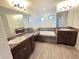 Bright bathroom with dual sinks, soaking tub, and granite countertops at 11240 Marvelwood, Brooksville, FL 34614