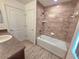 Bathroom vanity beside the shower-tub combination with white subway tile at 11240 Marvelwood, Brooksville, FL 34614