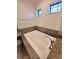 Soaking tub with stone-look surround and modern faucet at 11240 Marvelwood, Brooksville, FL 34614