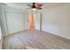 Bedroom with ceiling fan, closet with bi-fold doors, and wood-look tile flooring at 11240 Marvelwood, Brooksville, FL 34614