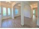 Open foyer with wood-look tile flooring and an arched entryway at 11240 Marvelwood, Brooksville, FL 34614