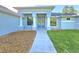 Inviting front entrance with a modern walkway and decorative stone feature at 11240 Marvelwood, Brooksville, FL 34614
