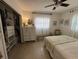 Comfortable bedroom featuring a bright window, ceiling fan, dresser, and open closet at 11376 119Th Ter, Largo, FL 33778