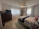 Bright bedroom with ceiling fan, windows, and neutral tones, creating a relaxing atmosphere at 11376 119Th Ter, Largo, FL 33778