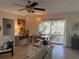 Bright dining area featuring a wooden table, colorful rug, and sliding doors to the outdoor patio at 11376 119Th Ter, Largo, FL 33778