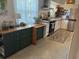 Updated kitchen with green cabinets and modern appliances at 11376 119Th Ter, Largo, FL 33778