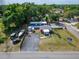 An aerial view showcasing the commercial property with a mobile home and ample parking in a green environment at 126 Ridgewood Ave, Brandon, FL 33510