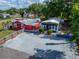 An aerial view shows the building and its parking spaces, surrounded by lush trees at 126 Ridgewood Ave, Brandon, FL 33510