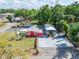 An aerial view of the salon and mobile home with a parking area and surrounding greenery at 126 Ridgewood Ave, Brandon, FL 33510