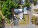 Aerial view of a building surrounded by lush greenery with a boat stored and dark paved driveway at 126 Ridgewood Ave, Brandon, FL 33510