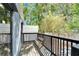 Cozy outdoor balcony with wooden bench and railing offers a relaxing spot surrounded by lush greenery at 126 Ridgewood Ave, Brandon, FL 33510