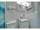 Cozy bathroom featuring a white toilet, white sink, white cabinets and white tiled walls at 126 Ridgewood Ave, Brandon, FL 33510