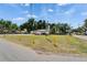 A charming commercial space with yellow bollards in front of the property with grass and a sign at 126 Ridgewood Ave, Brandon, FL 33510