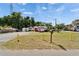 Exterior view of red building with small front porch and large front yard at 126 Ridgewood Ave, Brandon, FL 33510