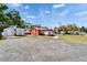 Wide exterior view showcases the parking space in front of the red and white commercial building at 126 Ridgewood Ave, Brandon, FL 33510