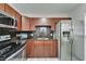 This kitchen features stainless steel appliances, granite countertops, and wood cabinets at 126 Ridgewood Ave, Brandon, FL 33510