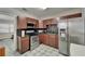 The kitchen features stainless steel appliances, wood cabinets, and ample countertop space at 126 Ridgewood Ave, Brandon, FL 33510