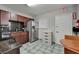This kitchen features stainless steel appliances, granite countertops, and a nearby dining area at 126 Ridgewood Ave, Brandon, FL 33510