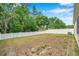 Large backyard with grass and a white vinyl fence offering privacy and plenty of room for activities at 12831 White Bluff Rd, Hudson, FL 34669