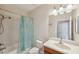 Well-lit bathroom with a shower/tub combo, toilet, and vanity with a mirror at 12831 White Bluff Rd, Hudson, FL 34669