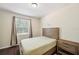 Cozy bedroom with a wood bed frame, a window with curtains, and a matching nightstand at 12831 White Bluff Rd, Hudson, FL 34669