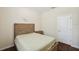 Bedroom with a bed, nightstand, decorative wall art, and a convenient door at 12831 White Bluff Rd, Hudson, FL 34669