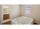 Cozy bedroom with a bathroom view and natural light offers a comfortable space at 12831 White Bluff Rd, Hudson, FL 34669