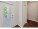 Bright entryway featuring wood-look floors, a closet, and a glass-paneled door leading to the exterior at 12831 White Bluff Rd, Hudson, FL 34669