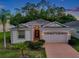Beautiful single-Gathering home with well-kept landscaping, neutral colors, and a two-car garage at 12831 White Bluff Rd, Hudson, FL 34669