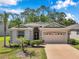 Charming single-story home with a well-maintained lawn, a two-car garage, and tasteful landscaping at 12831 White Bluff Rd, Hudson, FL 34669