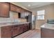 Kitchen features wood cabinets, granite counters, stainless refrigerator and stainless sink with modern faucet at 12831 White Bluff Rd, Hudson, FL 34669