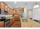 Spacious kitchen featuring granite countertops, stainless steel appliances, and ample cabinet storage at 12831 White Bluff Rd, Hudson, FL 34669