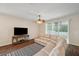 Comfortable living room with a plush sectional sofa, wood-look floors, and a sliding glass door at 12831 White Bluff Rd, Hudson, FL 34669