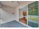 View of the kitchen from screened patio with ceiling fan, wood floors and stainless steel appliances at 12831 White Bluff Rd, Hudson, FL 34669