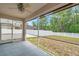Spacious screened porch with a ceiling fan and views of the backyard and white vinyl fence at 12831 White Bluff Rd, Hudson, FL 34669