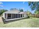 Expansive backyard with a screened-in porch, perfect for outdoor entertaining and relaxation at 13613 Laraway Dr, Riverview, FL 33579